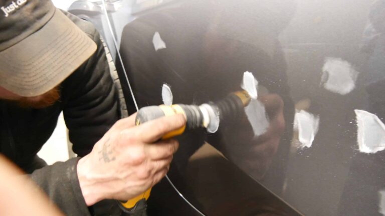 Spachtelstellen werden an der Fahrzeugtür fein geschliffen